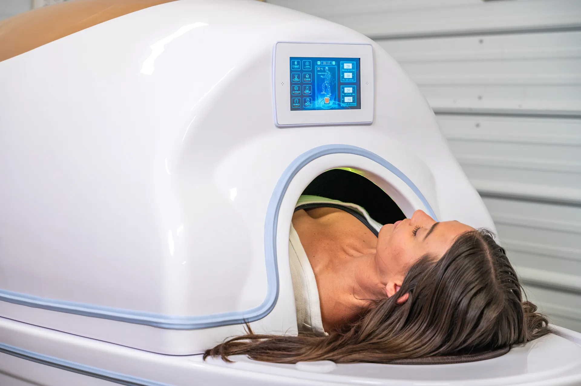 Woman enjoying a relaxing Emersion Wellness Pod Session