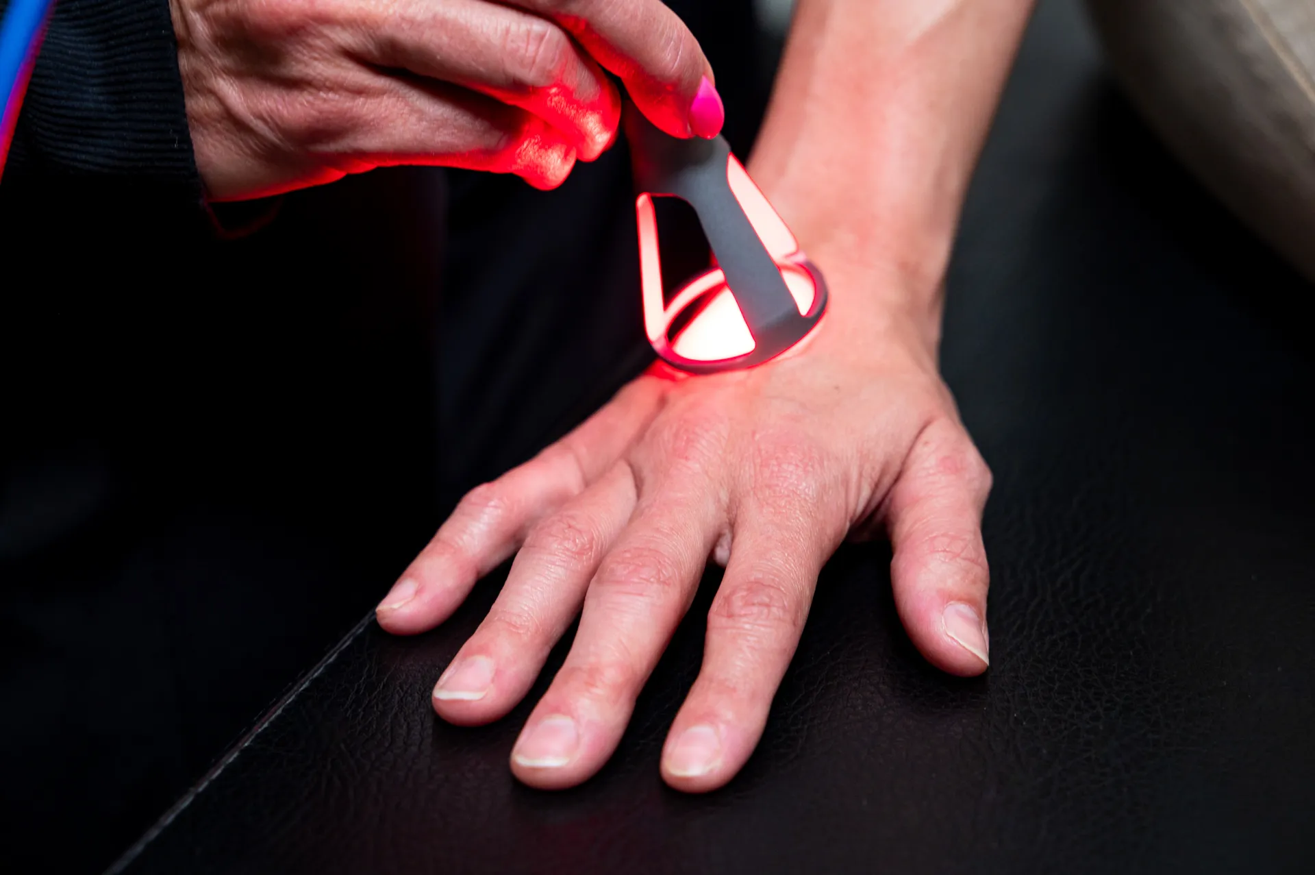 Class 4 laser therapy targeting a hand for pain relief