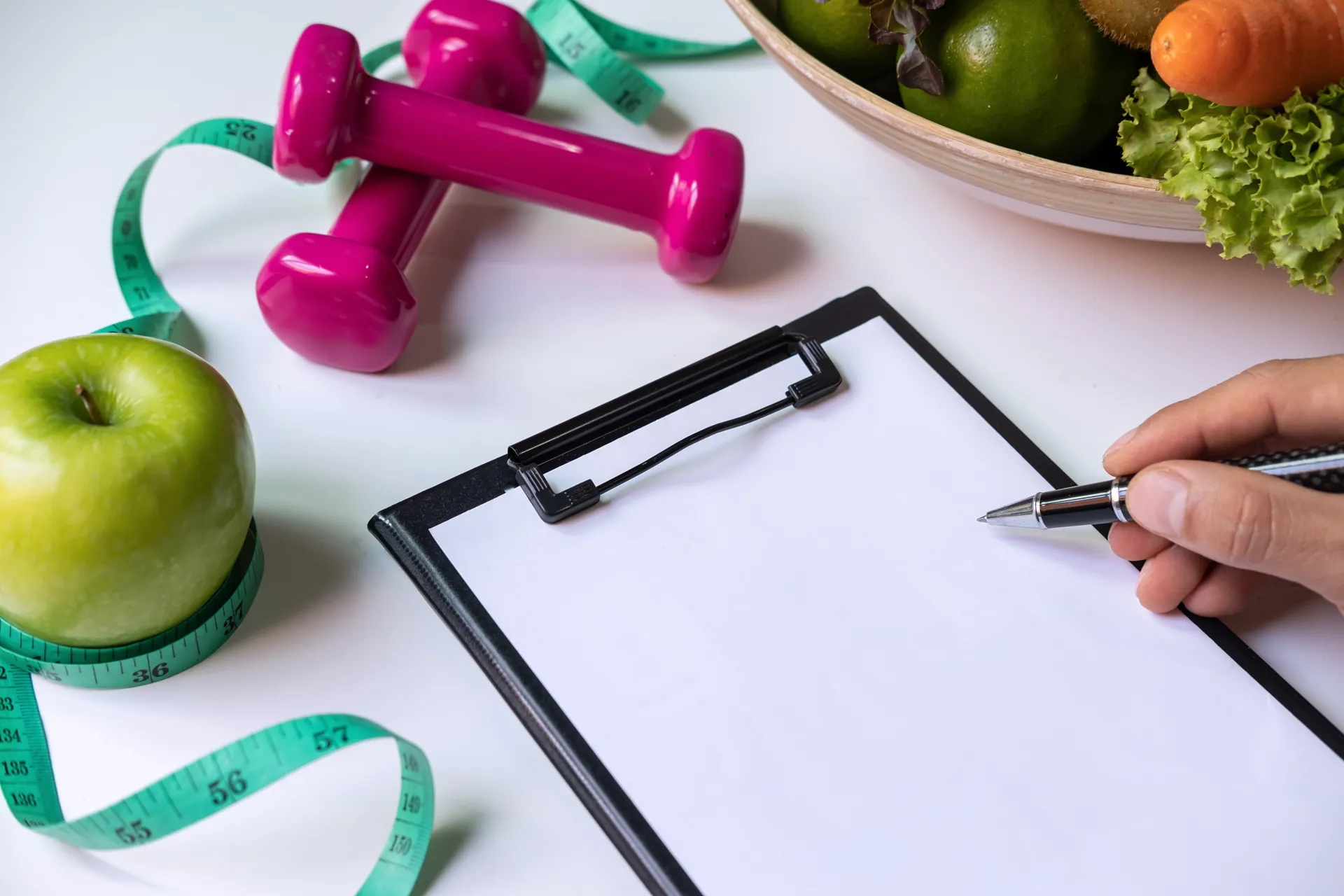 writing on a clipboard for health & nutrition consultations