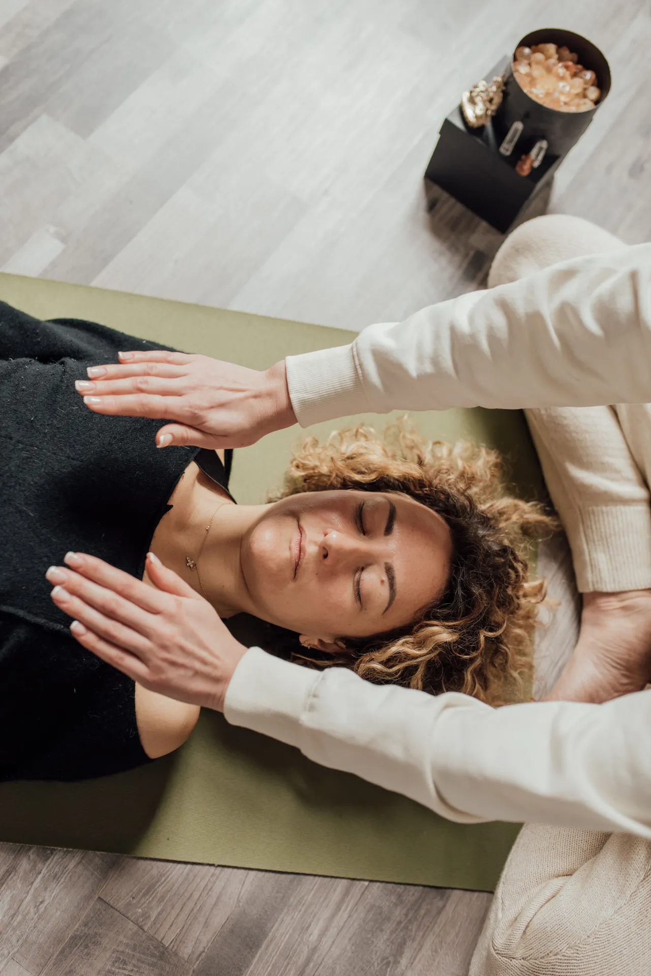 top down photograph of a woman performing reiki energy healing on another woman