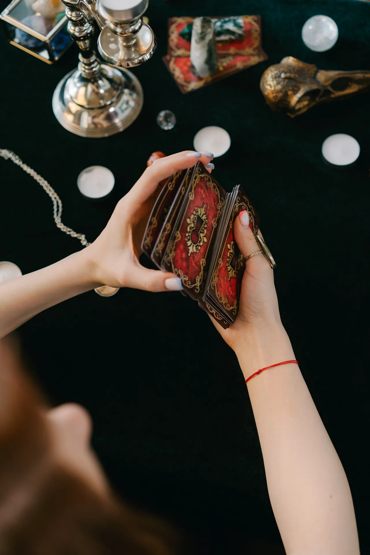 Woman shuffling a tarot card deck for a reading