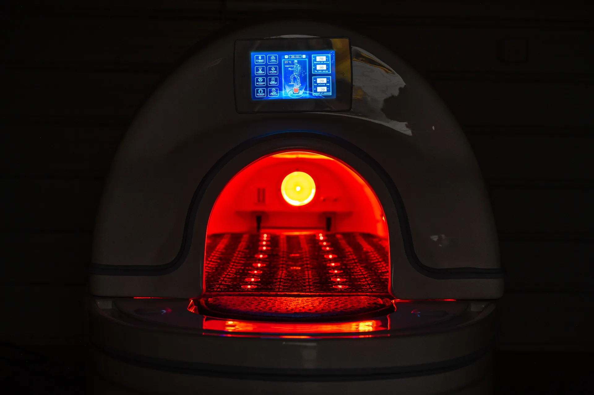Emersion Wellness Pod glowing in the dark showing the infrared and multi spectrum lighting